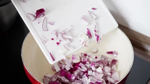 Diced Red Onion Falling Into Hot Pan, Elderly Caucasian Hand Transfers Chopped Video stock 323941256