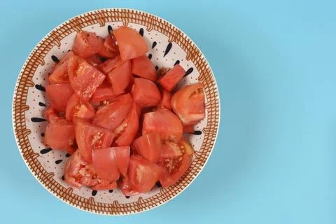 Diced red tomatoes in a patterned ceramic bowl Stock Photos