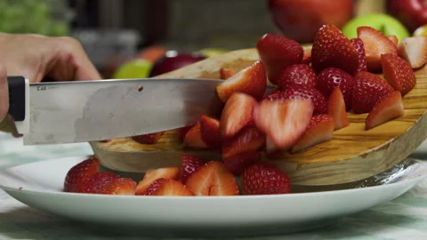 Diced strawberries being dropped onto plate - closeup, slow motion shot Stock Footage 341238232