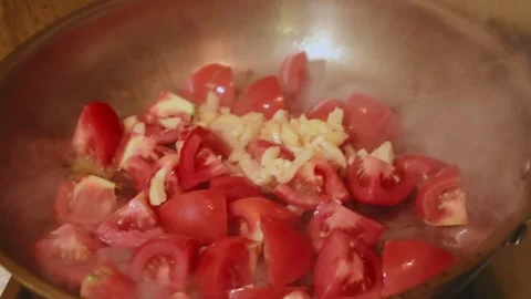 Diced Tomatoes and Garlic Stir Frying in a Stainless Steel Pan Vídeos de archivo 344670627