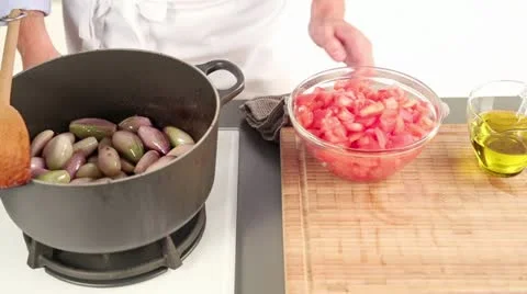 Diced tomatoes being added to fried shallots 스톡 동영상 24658272