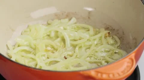 Diced vegetables being added to fried onions Stock Footage 24656834