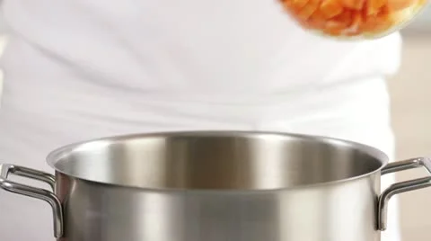 Diced vegetables being added to a pot Stock Footage 24662191