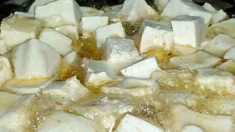 Diced white tofu fried in boiling hot oil. Stock Footage 329086483