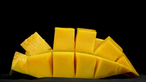 Diced Yellow Mango Slice Rotating on Black Background 库存影片 335256832