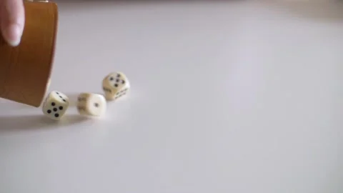 Dices are rolling slowly out of a dice cup Stock Footage 153661163