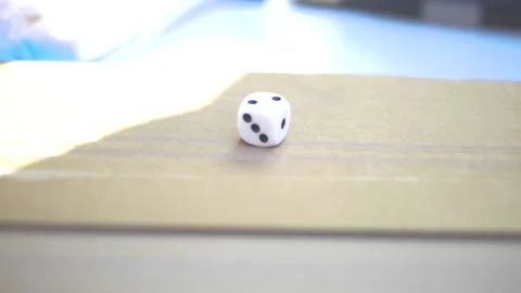 Dices being thrown in slow motion in sunlight Stock Footage 229410613