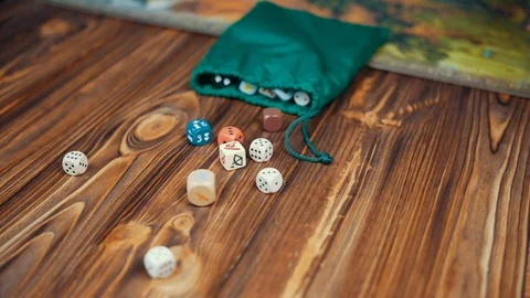 Dices Fall On a Wooden Table From Bag Stock Footage 72501312