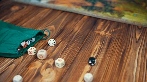Dices Fall On a Wooden Table From Bag 스톡 동영상 72559269