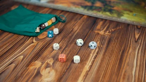Dices Fall On a Wooden Table From Bag Stock Footage 72638196