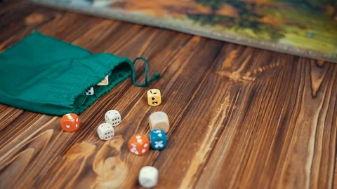 Dices Fall On a Wooden Table From Bag Stock Footage 72639506