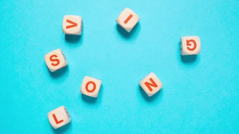 Dices spelling "solving" in stop motion Stock Footage 129810597