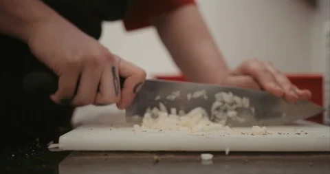 Dicing up onion in the back of a kitchen Video stock 105297625