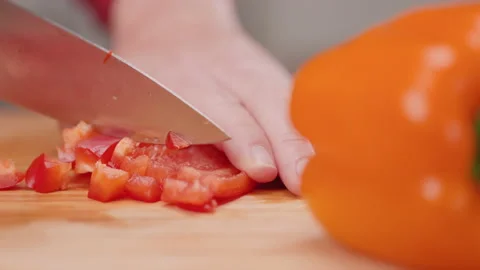 Dicing Red Bell Pepper Move Left from Out of Focus Peppers Video stock 155113866