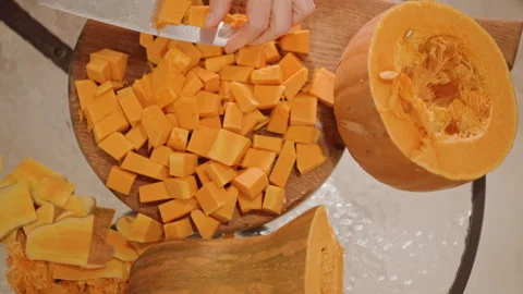 Dicing roasted squash for pie. Home cook preparing pumpkin for baking. Handson Stock Footage 346392543