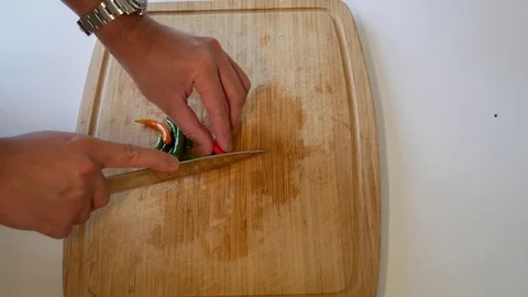 Dicing Thai chilis on a cutting board Stock Footage 79296213