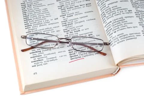 The dictionary and spectacles Stock Photos