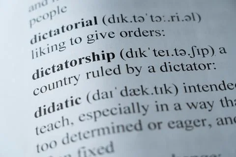 Dictionary page with the word dictatorship with selective focussing Stock Photos