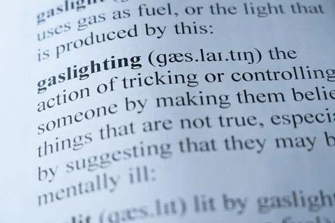 Dictionary page with the word gaslighting with selective focussing Stock Photos