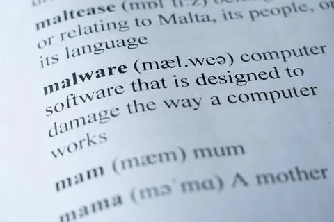 Dictionary page with the word malware with selective focussing Stock Photos