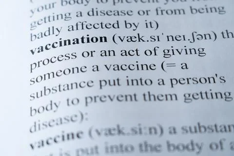 Dictionary page with the word vaccination with selective focussing Stock Photos