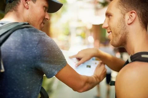 Did we zig instead of zag. two smiling young friends wearing backpacks traveling Stock Photos