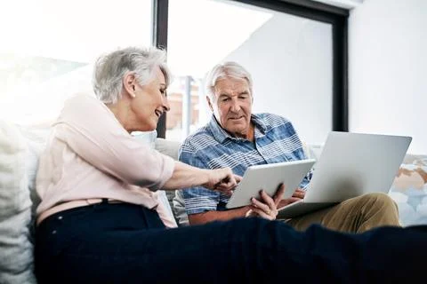 Did you see this function. a senior woman using digital tablet while her husband Stock Photos