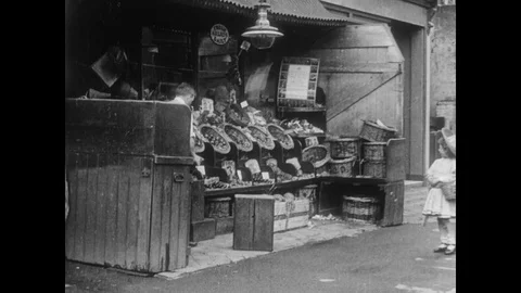 Diddums steals fruit in a store and hides it in a basket, UK 1912 Stock Footage 136673499