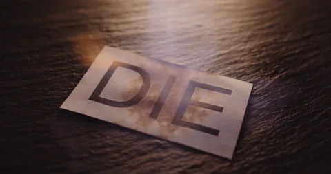 Die text on paper, hot burning on black background. Flames and fire. 스톡 동영상 152061129