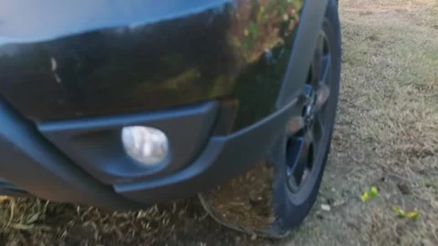 Diesel car reversing close-up side shot showing vehicle moving backward over Stock Footage 333617624