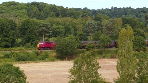 Diesel engine pulling classic steam train carriages Stock Footage 80322584