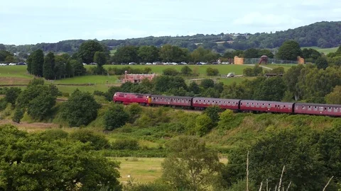 Diesel engine pulling classic steam train carriages Stock Footage 80323762