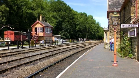 Diesel engine pulling steam train carriages country station Stock Footage 80304819