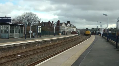 Diesel goods engine passing through station victorian hotel Stock Footage 47214093