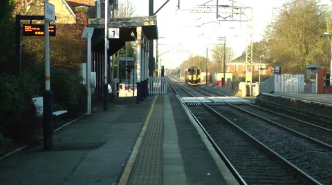 Diesel passenger train approaching rural station Stock Footage 47072580