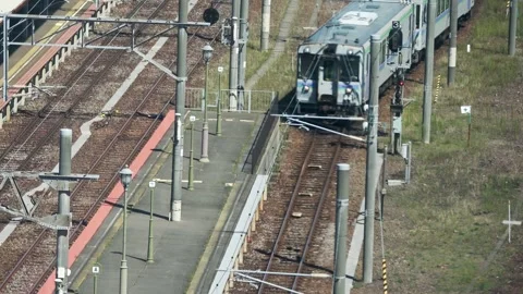 Diesel railcar slowly pulling into platform, Hakodate, Japan, 2026.09.10. Stock Footage 345363555