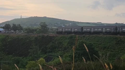 Diesel train passing through dolcoath mine camborne on the way to redruth Video stock 244522656