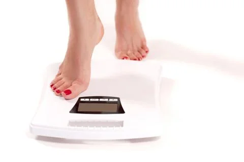 Diet and Weight Loss. Woman standing on weight scale Stock Photos