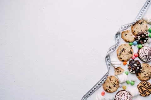 Diet. candy and cookie background and measure tape Stock Photos