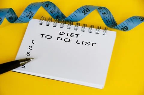 Diet to do list text on white notepad with blue measuring tape on yellow ba.. Stock Photos