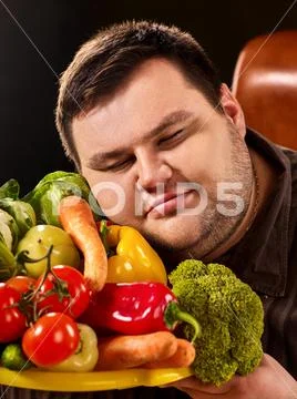 Diet fat man eating healthy food . Healthy breakfast with vegetables. Stock Photos