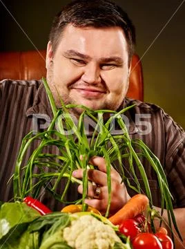 Diet fat man eating healthy food. Healthy breakfast with vegetables. Stock Photos
