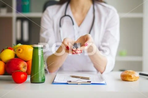 Diet. Female Nutritionist Holding Blisters of Pills Stock Photos