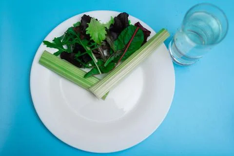 Diet, interval eating, fasting concept. A plate of vegetables depicting a clo Stock Photos