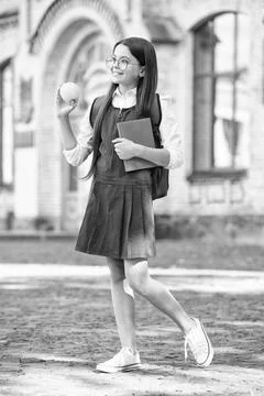 Diet makes difference to learning. Happy child hold apple and book. School break Foto stock