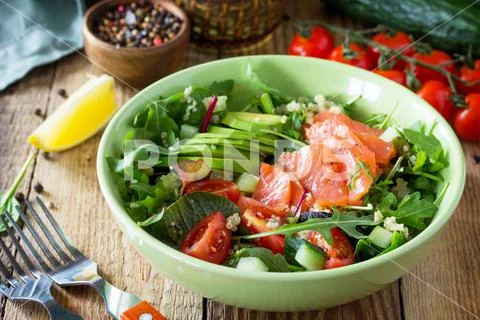 Diet menu, Vegan food. Healthy salad with quinoa, arugula, Tomatoes, Salmon. Stock-Fotos
