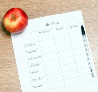 Diet Plan. diet plan, pencil and apple lying on a wooden surface Stock Photos