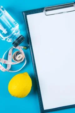 The diet plan. White sheet on the tablet among the bottles with water and app Stock Photos