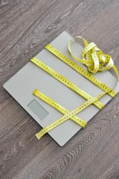 Diet problems concept with weight scale and measuring tape Fotos Stock