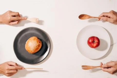 Diet struggle and deciding between nutrition choice dilemma between healthy g Foto stock